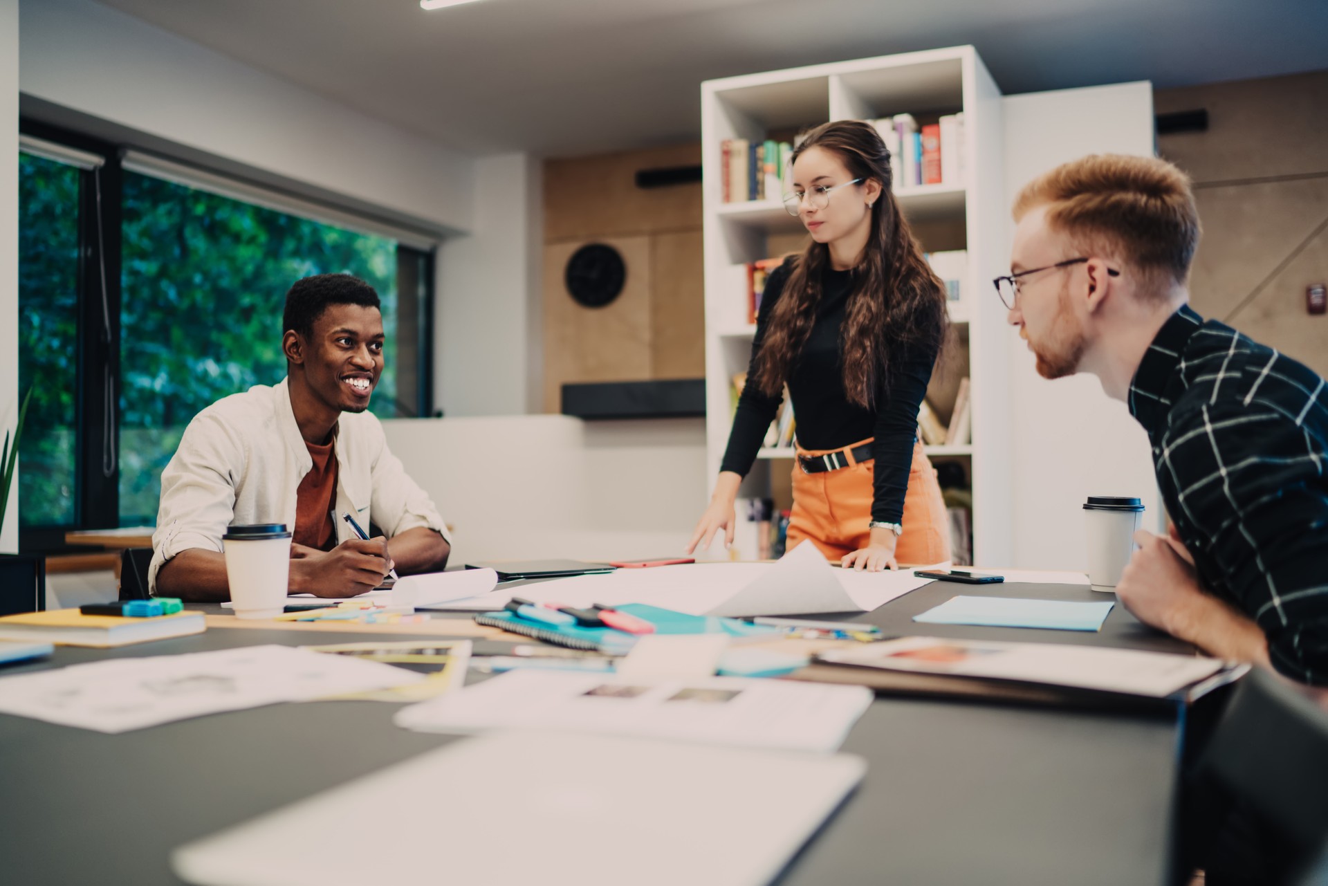 Smiling students studying in creative workplace